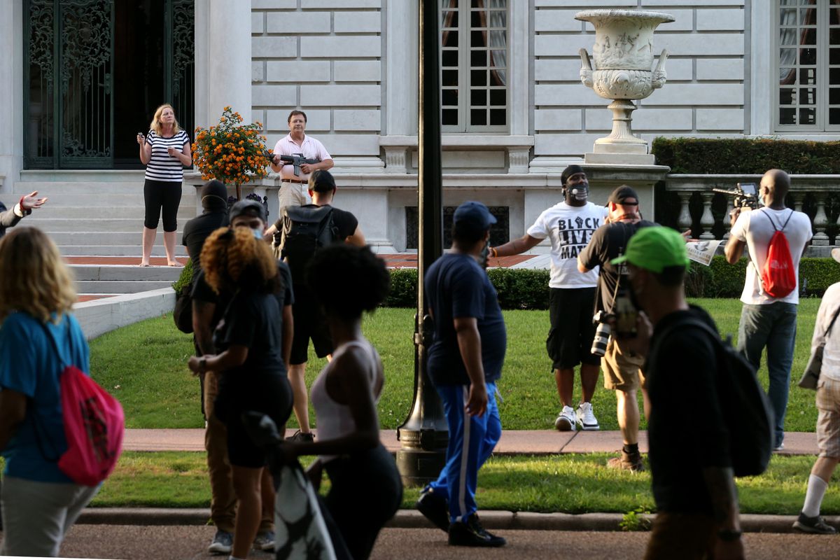 couple charged for pointing guns at protesters