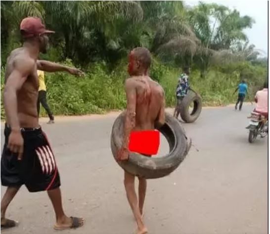 Moment suspected kidnapper is stripped, beaten, paraded 
