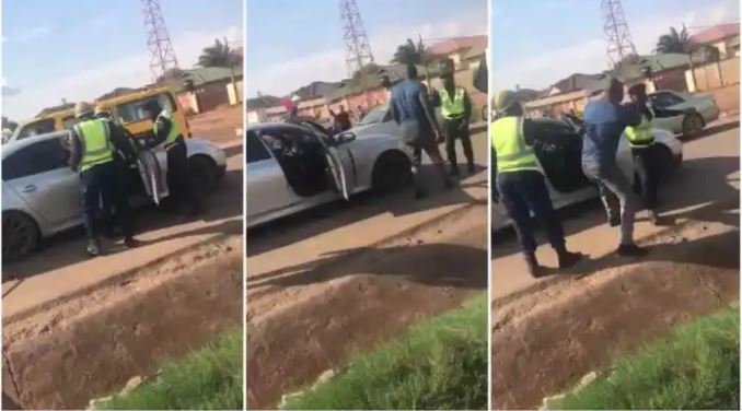 Watch|| Man Fights Police Officers, Throws One Into Gutter
