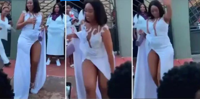Beautiful Lady With High-Slit Dress Causes Stir At Event As She Struggles To Cover Her Nature (Watch Video)