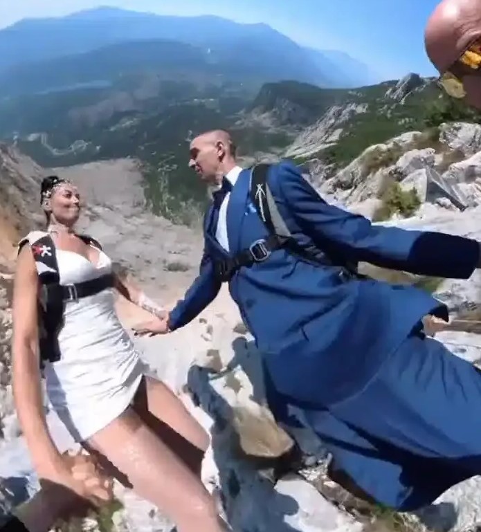 Pastor Officiates Wedding On A Cliff, Orders Couple To Jump Off Cliff In Parachutes