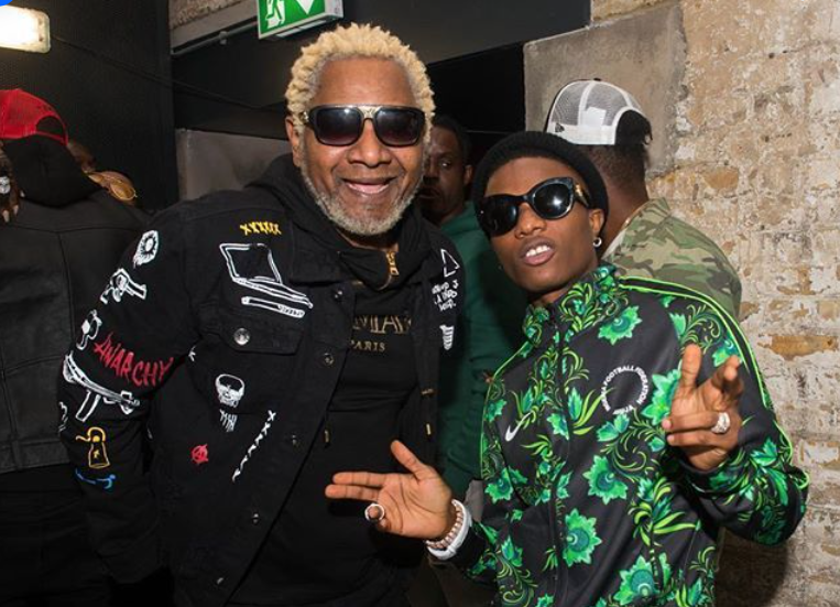 Tay Grin’s 20-Year Music Bash to Feature WizKid & Awilo Longomba – But Awilo’s Past No-Show Scandal Has Fans Talking